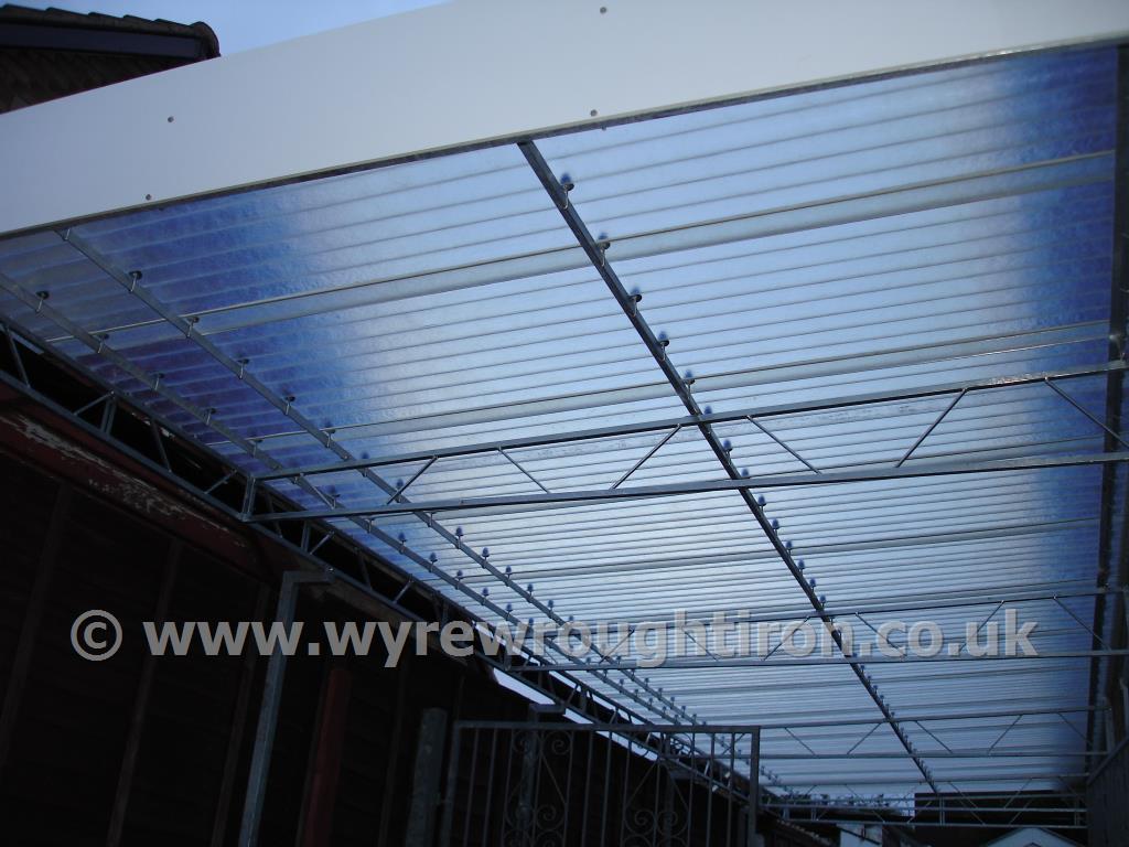 Photo - Detail of carport in Fleetwood showing steel structure and near transparent fibreglass roof