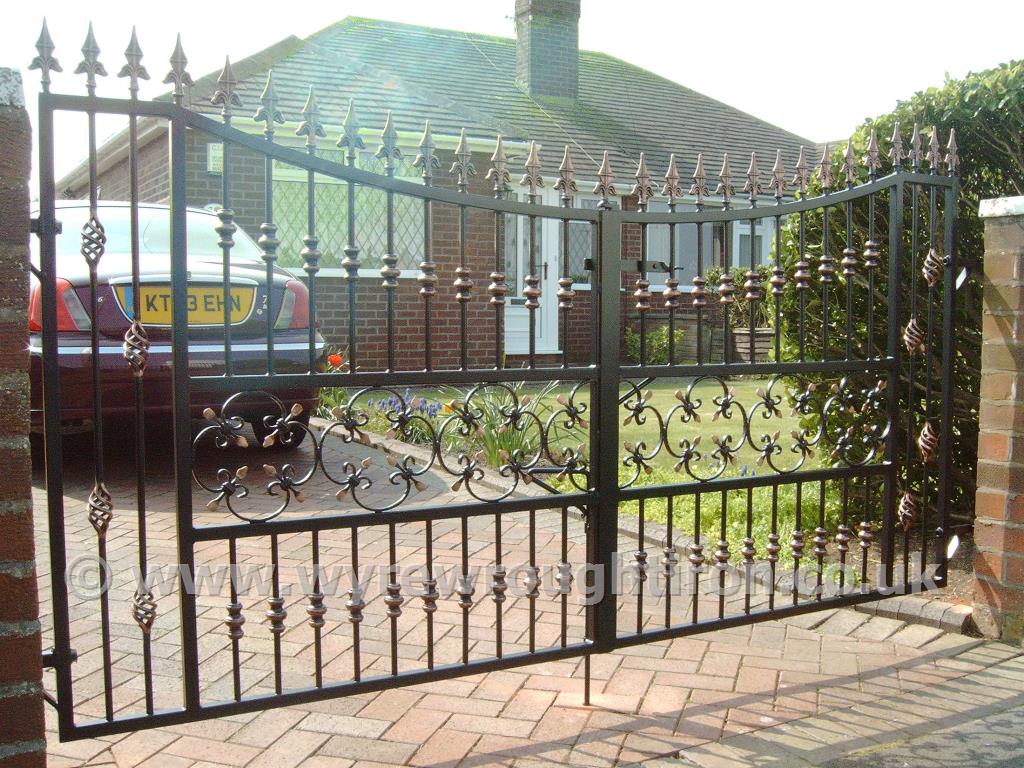 Double gates with drop arches, railheads, cage twists, barrels and scrollwork, galvanised and powder coated in black for customer in Rossall, Fleetwood.