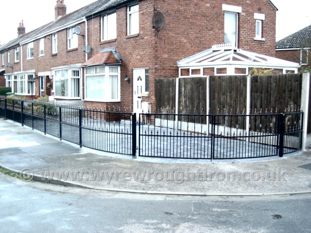 Curved gates and matching railings with flat top, railheads and barrels, black powder coated finish and gold detailing for Thornton customer.