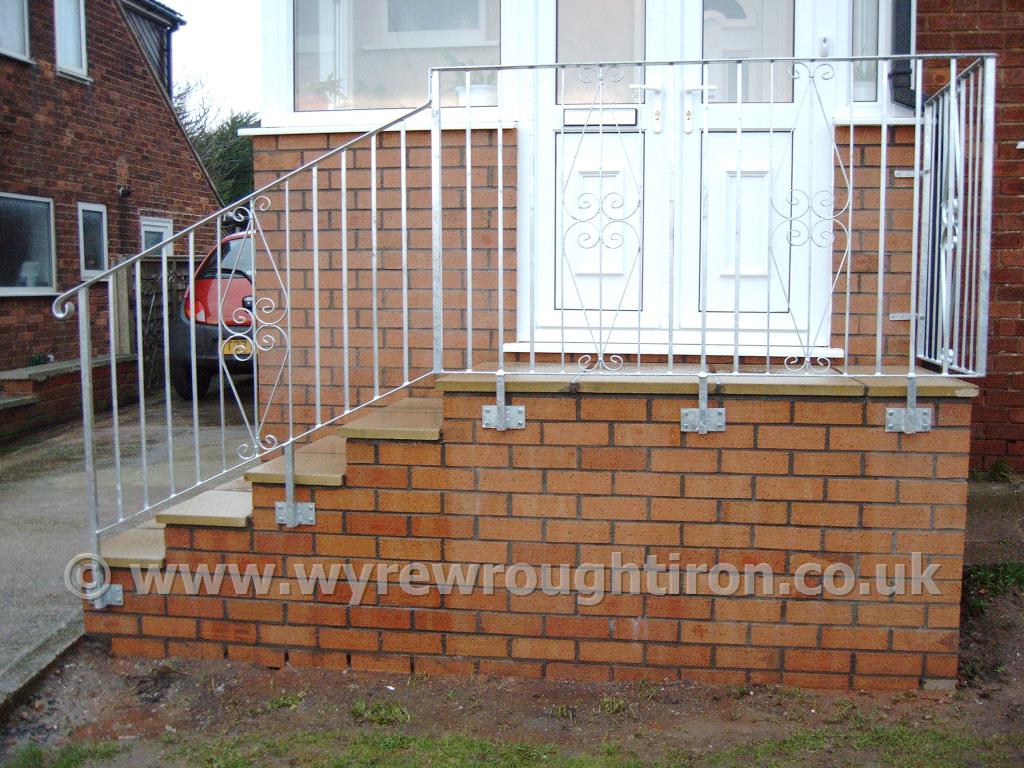 A scrolled wrought iron handrail with galvanised finish fitted to front door steps for a customer in Knott End.