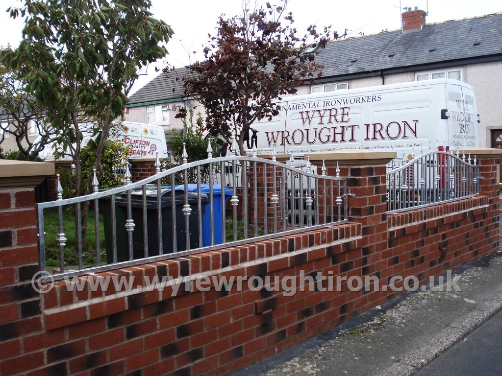 Arch garden wall railings with railhead, bush detail and galvanised finish for Fleetwood garden.