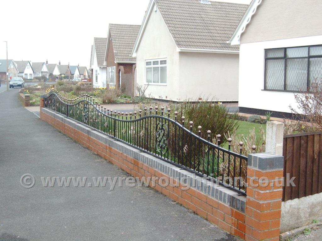 Arched top railings with ball railheads, cage twists, scrollwork and hand painted gold finishing, installed at Fleetwood property.